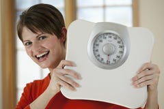 Attractive Woman Holding a Bathroom Scale Stock Photography