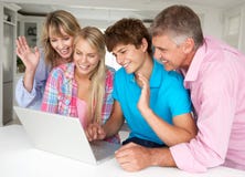 Family using laptop at home Stock Image