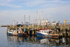 Stock Images: Commercial fishing boats by a wood dock