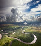 Forest river under the white clouds Stock Photography