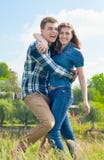 Happy Young couple in fun hugging & blue sky Royalty Free Stock Photography