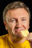 A man eats a lemon Stock Photo - man-eats-lemon-black-background-33440570