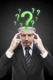Open minded man with Green question marks inside Stock Image
