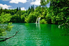 A peaceful lake and waterfal Stock Photos