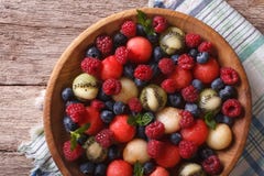 Delicious juicy raspberries in a wooden bowl Top view