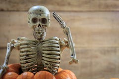 skeleton-saluting-pumpkin-blur-backgroun