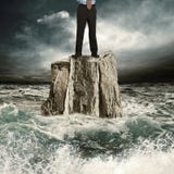 Standing on the rock in the sea Royalty Free Stock Photos