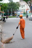 Street sweeper in orange, Vietnam Royalty Free Stock Images