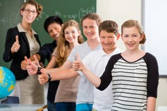 Teacher motivating students in school class Stock Images