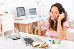 Young attractive student drinking water while working Royalty Free ...