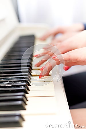 Сlose up view of hands playing piano