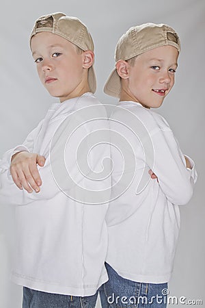 6 years old identical twins wearina a baseball hat
