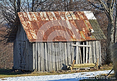 Abandoned old wooden barn with rusted roof