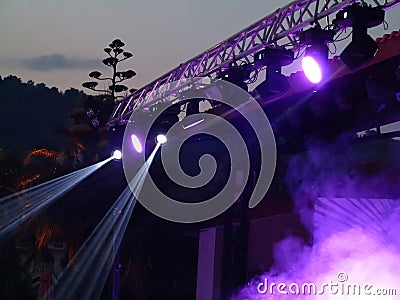 Abstract blue bright spotlights in open air stage