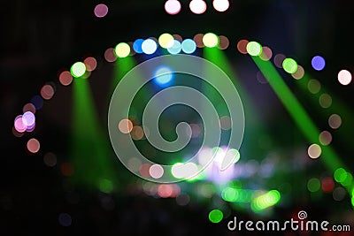 Abstract defocused color spotlights on concert