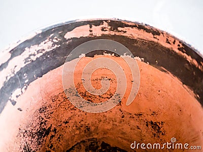 Abstract: detail of orange ceramic bowl edge with high key white background