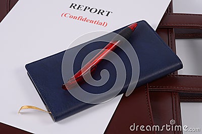 Red pen and blue notebook