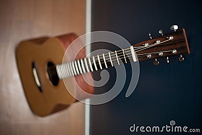 Acoustic Guitar Against a Wall