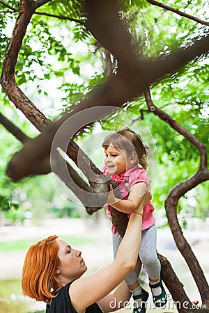 Active girl climbing on tree