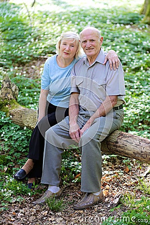 Active senior couple hiking in the forest