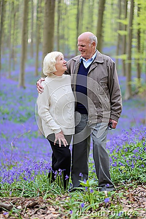 Active senior couple hiking in the forest