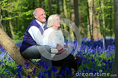 Active senior couple hiking in the forest
