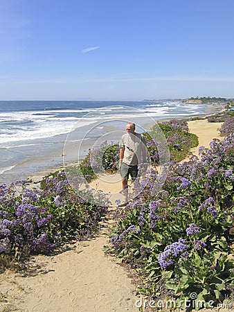Active senior man walking along coastal path