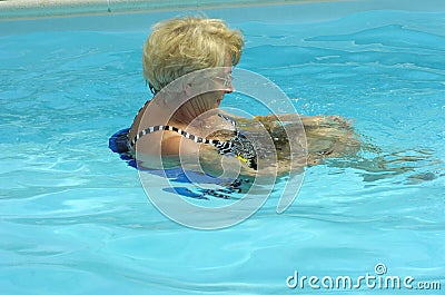 Active senior woman swimming