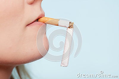 Addiction. Broken cigarette in mouth. Quit smoking