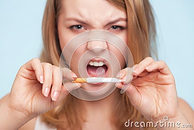 Addiction. Girl breaking cigarette. Quit smoking.