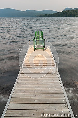 Adirondack chair on a wooden dock.