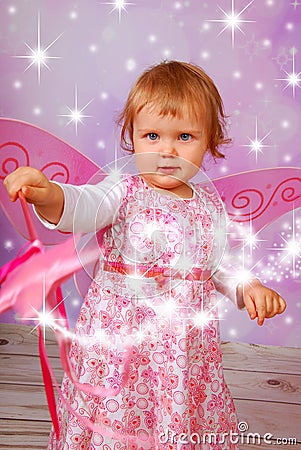 Adorable baby girl with fairy wings and wand