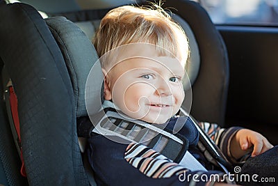 Adorable baby toddler in safety car seat