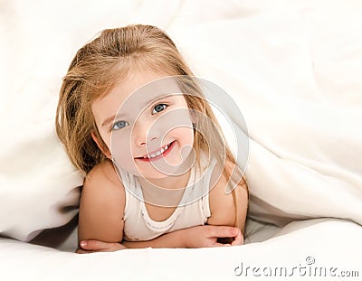 Adorable little girl waked up in bed