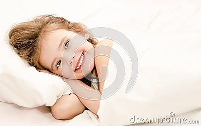 Adorable little girl waked up in her bed