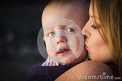 Adorable Red Head Infant Boy is Kissed By His Mother