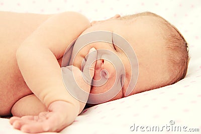Adorable tightly sleeping newborn baby girl