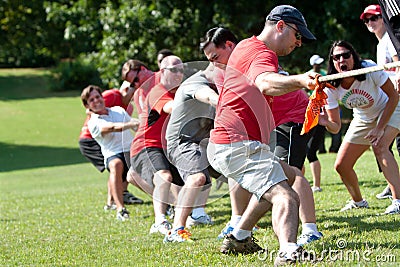Adults Pull Rope In Team Tug-Of-War Competition