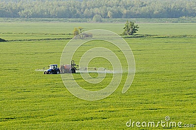 Aerial view of tractor spraying substances