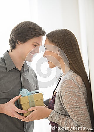Affectionate Man Giving Birthday Gift To Woman