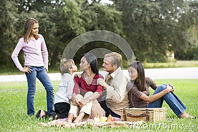 Affectionate modern multicultural family on picnic