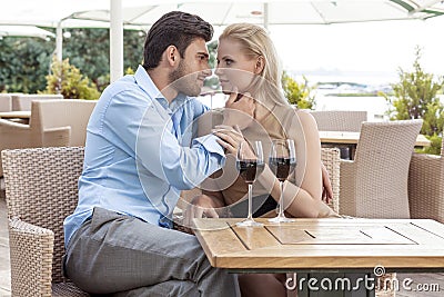 Affectionate young couple spending quality time at outdoor restaurant