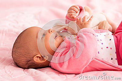 African american baby girl playing with a plush