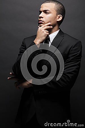 African-American business man in black suit.