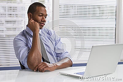 African American businessman at desk with computer, horizontal