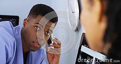 African American doctor talking to colleague