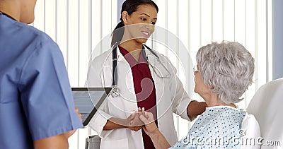 African American doctor talking to mature woman patient