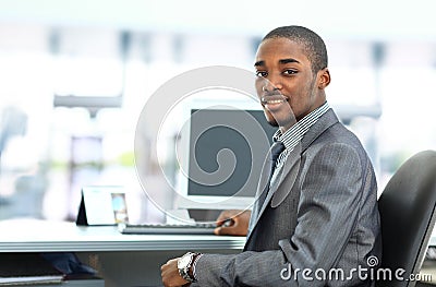 African American entrepreneur displaying computer laptop in office