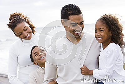 African-American family and two children on beach