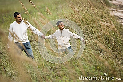 African-American father and son walking